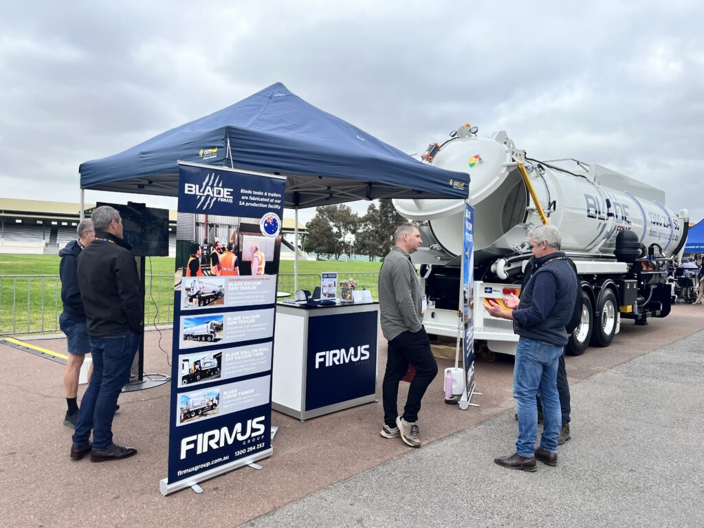 FIRMUS Group AUSJET24 Exhibition site - Blade Vacuum Semi Trailer in background with Heath Keenan